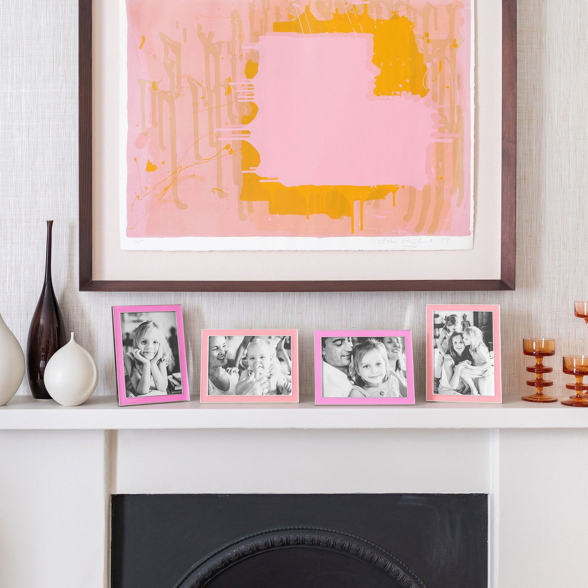 Four Silver Trim, Enamel Photo Frames on a mantlepiece