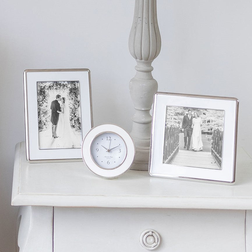 A pair of curved silver trim white enamel frames