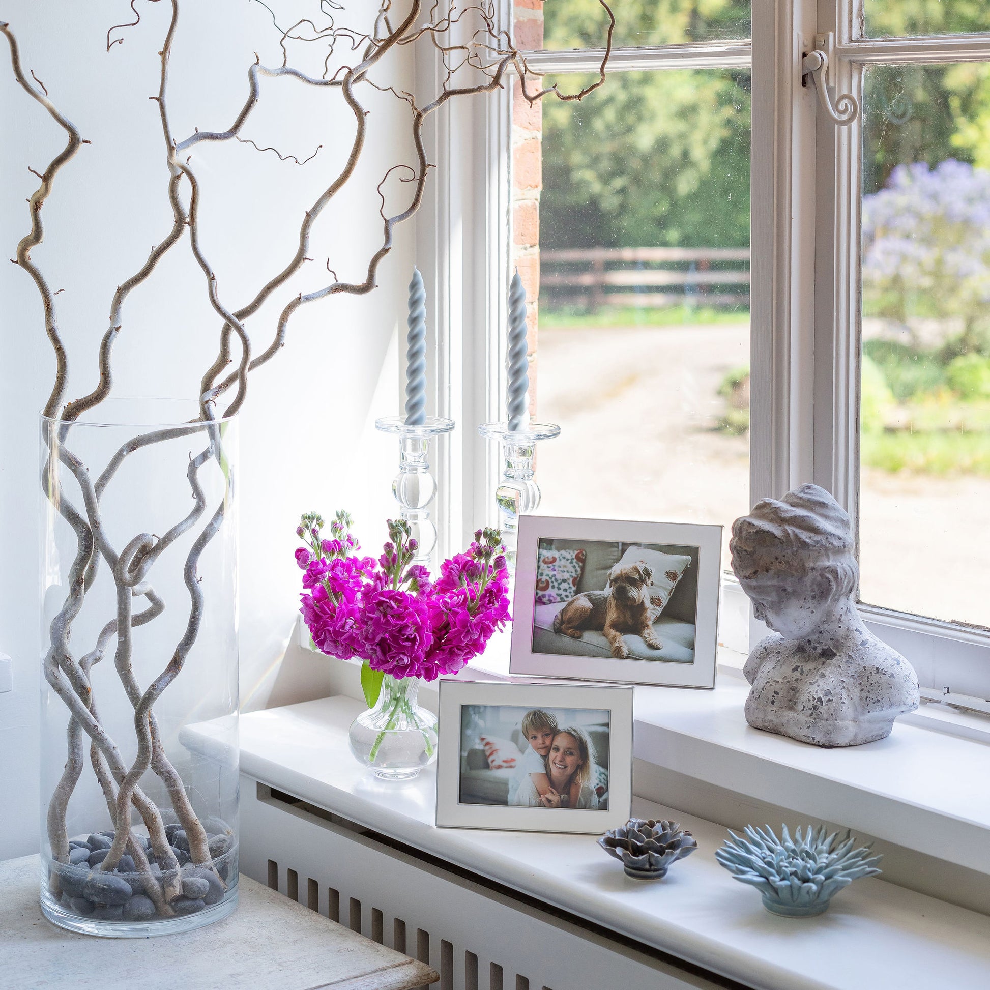 Two wide white enamel photo frames with silver trim