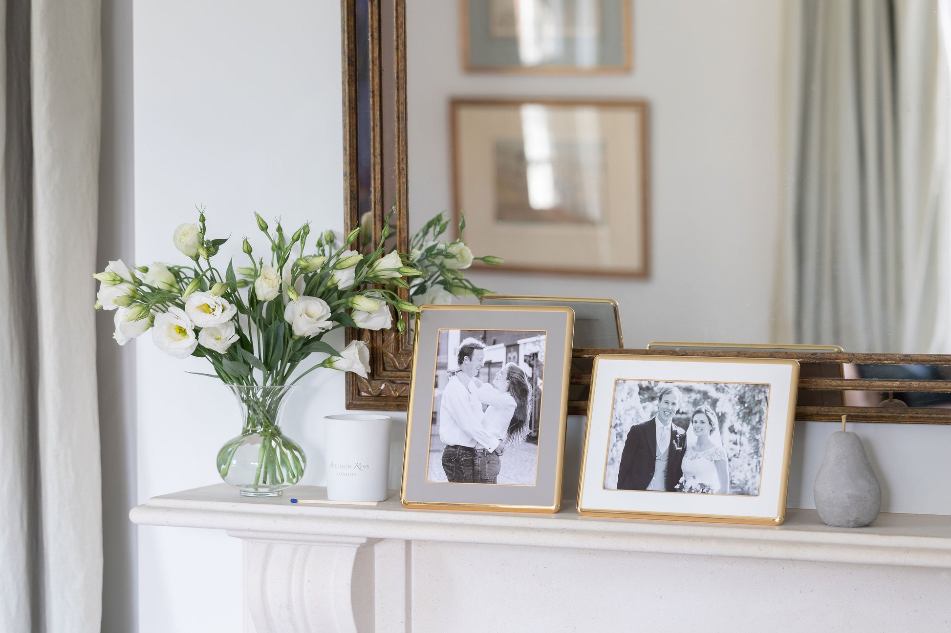 A pair of curved gold trim enamel photo frames